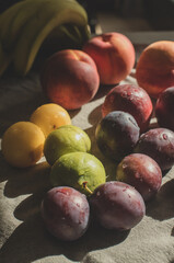 Ripe, Bright Peaches and Plums on the Table