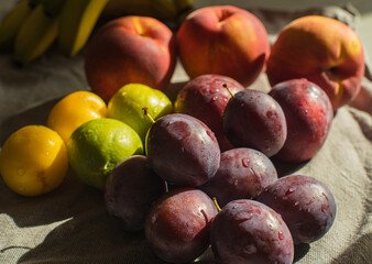 Ripe, Bright Peaches and Plums on the Table