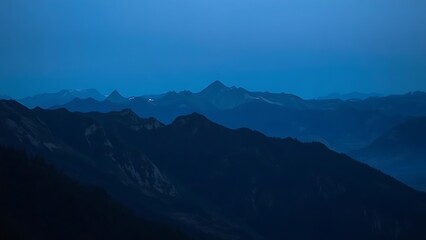 Fototapeta premium A mountain landscape during blue hour, with a soft twilight glow enhancing the natural scenery.