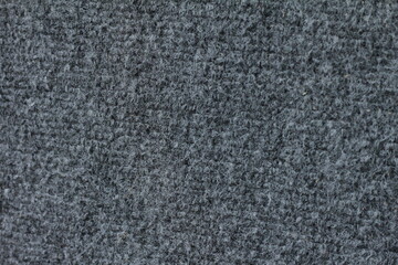 Fototapeta premium The gray background is made of fabric that has a coarse fibrous structure.