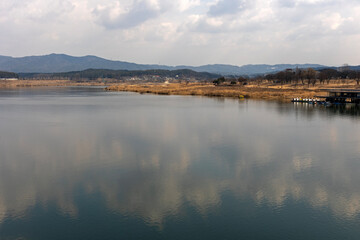 Blue sky and clouds reflected in the river