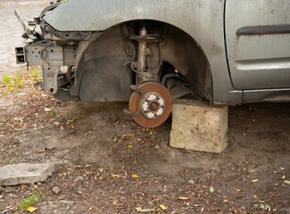 Car missing front wheel and bumper components