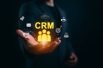 Business professional presenting CRM interface with digital icons – concept of customer relationship management, business tools, and strategic engagement