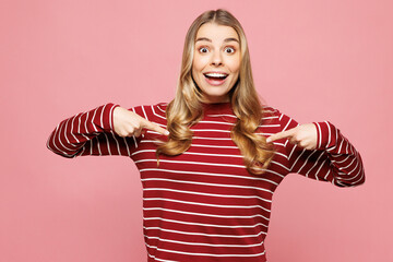 Young shocked happy woman she wear red striped sweatshirt casual clothes point index finger on...