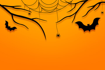 Halloween-themed items including branch, bats and spider web reatively on orange background for a festive holiday theme.