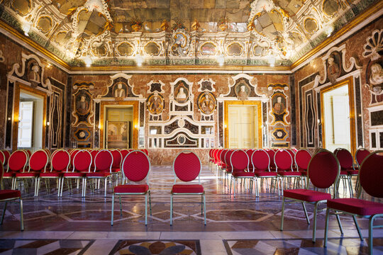 Interior of Villa Palagonia with ornate mirrors and red velvet chairs in the background, Bagheria, Sicily, Italy