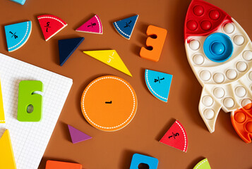 Colorful learning materials arranged on a brown surface for educational activities with shapes and numbers