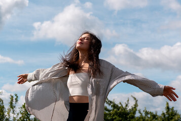 Beautiful woman enjoying a beautiful sunny day under the blue sky