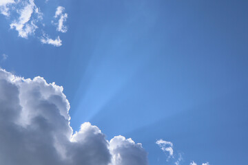 The sun's rays break through the clouds. A beautiful sky background.