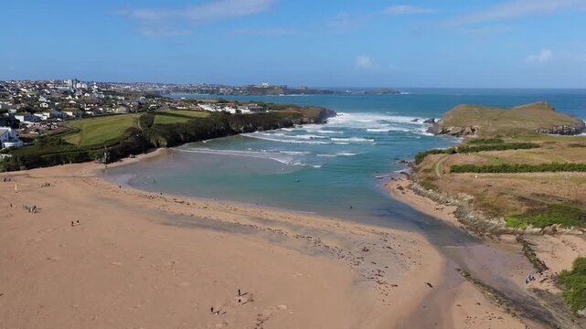 Surf and waves Mawgan Porth north Cornwall England near Newquay and south of Porthcothan and Treyarnon on a summer day with blue sk