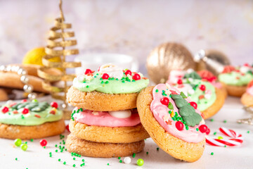 Festive Christmas decorated crumble cookies. Tasty american crumbl cookies copycat with green and red whipped cream frosting and Christmas sugar decorations on top, copy space