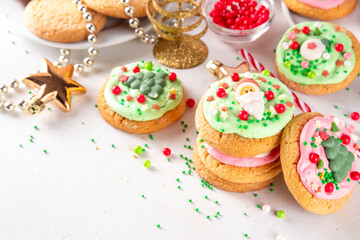 Festive Christmas decorated crumble cookies. Tasty american crumbl cookies copycat with green and red whipped cream frosting and Christmas sugar decorations on top, copy space