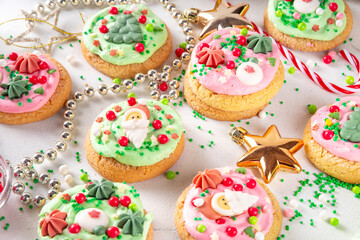Festive Christmas decorated crumble cookies. Tasty american crumbl cookies copycat with green and red whipped cream frosting and Christmas sugar decorations on top, copy space