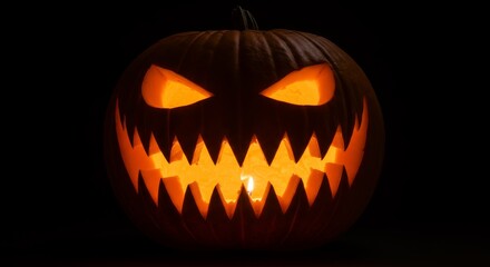 Fototapeta premium Illuminated Jack-o'-Lantern with Spooky Face and Glowing Candle Light