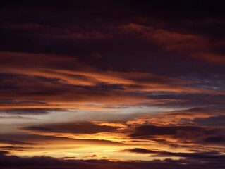 Fototapeta premium peace. A breathtaking sunset sky panorama with vibrant warm hues and glowing clouds. inspiring travel planning, travel magazines, designed for travel destination branding, inspires travel planning.