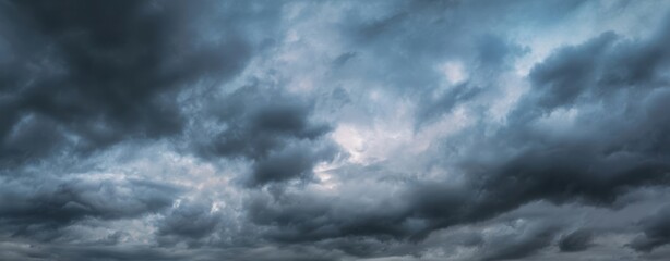 Fototapeta premium The Clouds Rolling in a Dramatic Moody Blue Storm Sky at Dusk