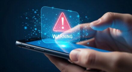 Hand holds smartphone displaying digital warning sign, a red triangle with exclamation mark, symbolizing alert, caution, and risk in online security or digital world