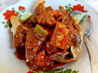 Close up batagor Indonesian dish with tofu and sauce. This iconic Indonesian dish is must try for anyone exploring Indonesian cuisine.