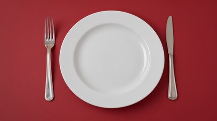 Empty plate on crimson canvas, evoking the contemplative minimalism of Yom Kippur fasting or phantom feast scarcity