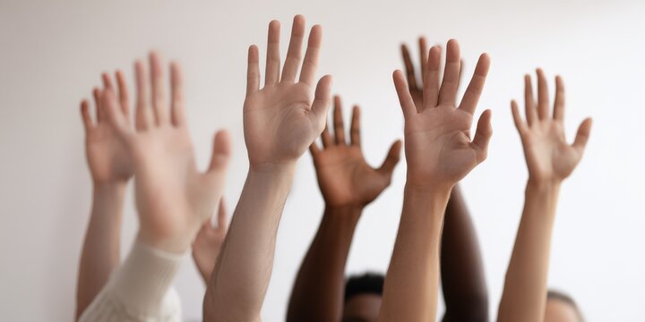 Diverse group raising hands volunteering together participation