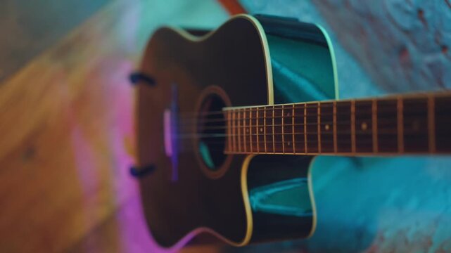 Guitar on a stand, acoustic guitar, close-up of an acoustic guitar