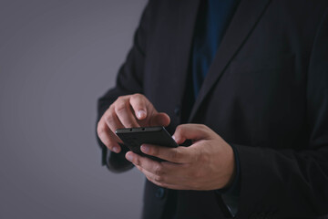 Businessman using smartphone, symbolizing digital communication, online business, mobile technology, internet browsing, social media, and modern work connection in business context.