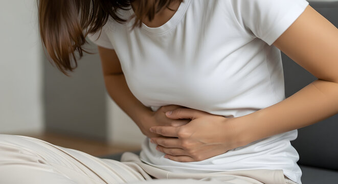 Woman experiencing stomach pain discomfort ache cramps holding abdomen feeling unwell health issue medical problem healthcare symptom illness