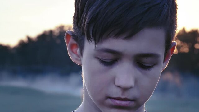 Defiant Gaze at Sunset: Portrait Revealing a Boy's Hidden Emotions