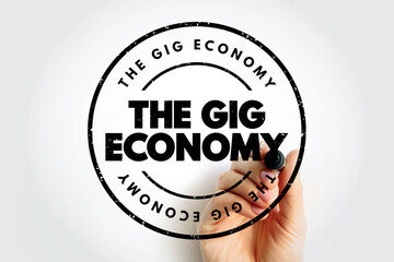 The Gig Economy is the economic system by which a workforce of people engage in freelance and side-hustle work, text concept stamp