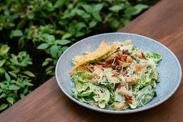 Caesar salad with romaine lettuce, croutons, bacon, and parmesan cheese