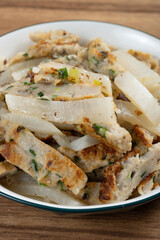 angle view home style pan-fried fish cakes with white radish at vertical composition