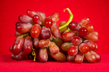 fresh grapes on a red background horizontal composition