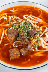 angle view spicy beef noodles with soup at vertical composition