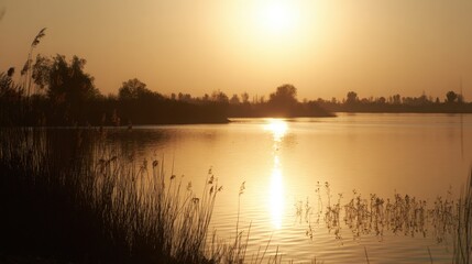 Obraz premium shore. Tranquil lakeside view at sunset with calm water reflecting golden hues. inspiring travel planning, travel magazines, designed for outdoor magazines and nature guides.