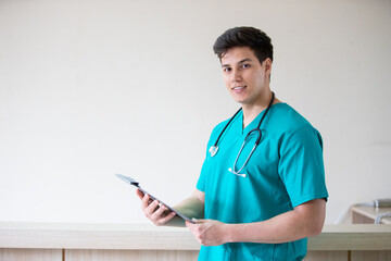 Portrait of adult man doctor stand with clipboard on the terrace