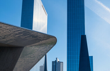 Modern architecture, Rotterdam Centraal stainless steel roof detail, glass high rise buildings and clear blue sky, Netherlands