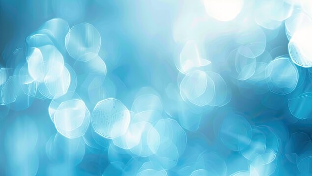 Abstract bokeh background with varying shades of blue, creating a dreamy and ethereal atmosphere.  Soft, out-of-focus circles of light dominate the composition