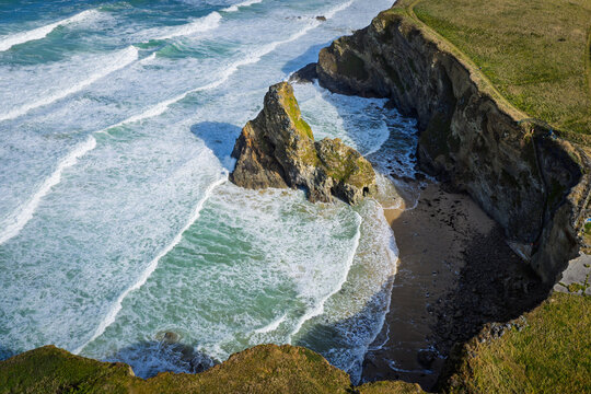 Surf and waves Mawgan Porth north Cornwall England near Newquay and south of Porthcothan and Treyarnon on a summer day with blue sk
