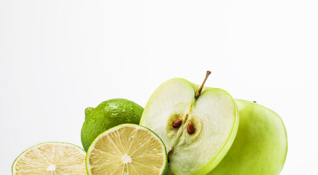 Still life of apples and limes together.