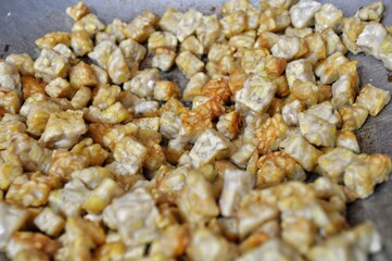 Golden Brown Tempeh Frying in Pan