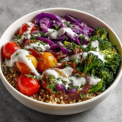 Healthy bowl of quinoa with roasted vegetables and a creamy dressing