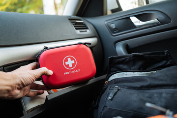 It is crucial to have an essential car emergency kit in your vehicle, which should ideally include a red first aid case stored conveniently in the vehicle console for easy access during emergencies