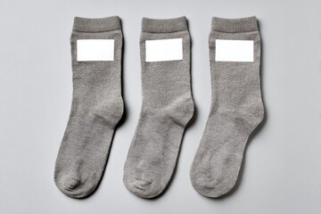 Three gray socks, each with a blank white label