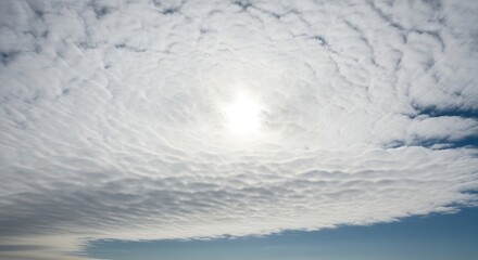 Obraz premium Expansive altocumulus clouds with a radiant sunburst illuminating the atmosphere