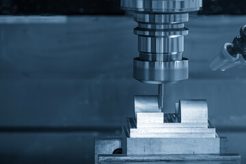 The CNC milling machine cutting mold part by solid ball nose end mill tool in the light blue scene.
