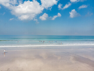 Low Tide Beach in Bali, Indonesia. Badung City. Ocean Water and Tourists in Background. Popular Spot Among Tourists and Local People