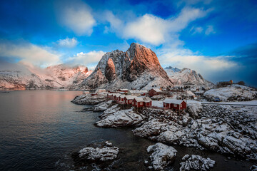 Picturesque Red Cabins in Snowy Lofoten with Mountain and Fjord View