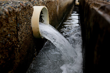 Wastewater Discharge from Industrial Drain Pipe into Sewer System