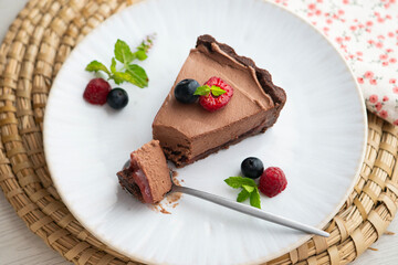 Chocolate mousse cake with red berries, blueberries, and raspberries.