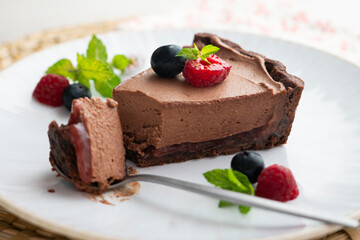 Chocolate mousse cake with red berries, blueberries, and raspberries.